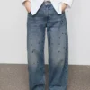 Jean à jambes droites avec œillets Jean à jambes droites avec œillets