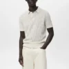 Polo en coton tricoté avec motif en dentelle Polo en coton tricoté avec motif en dentelle