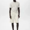 Polo en coton tricoté avec motif en dentelle Polo en coton tricoté avec motif en dentelle