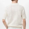 Polo en coton tricoté avec motif en dentelle Polo en coton tricoté avec motif en dentelle