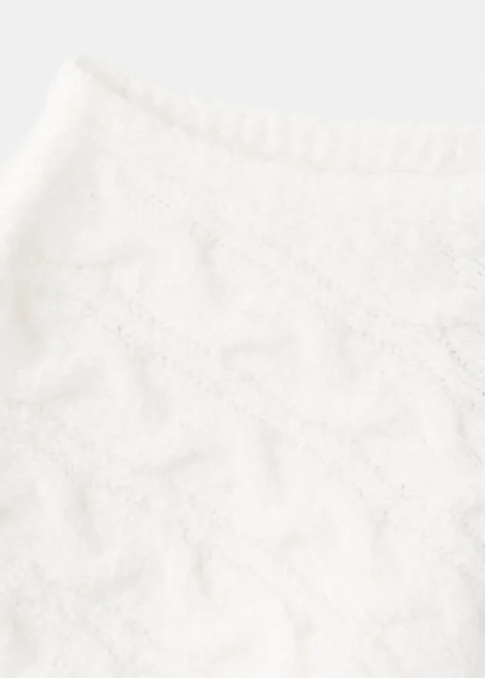 Poncho en maille torsadée